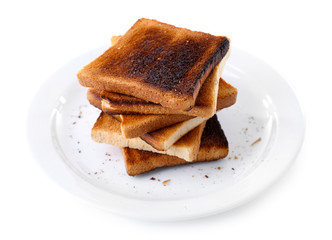 Burnt toast bread on plate, isolated on white background