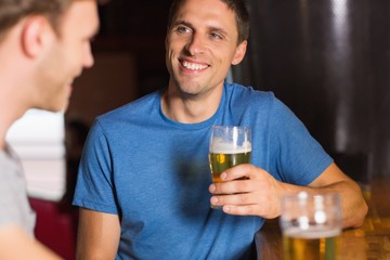 Happy friends catching up over pints
