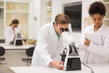 Medical students working with microscope