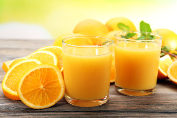 Obraz na płótnie Canvas Glass of orange juice and slices