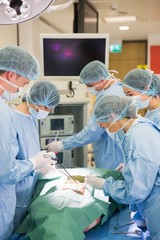 Medical students practicing surgery on model