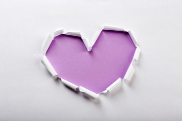 Naklejka na ściany i meble White torn paper heart over purple background