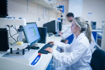 Fototapeta premium Food scientist using technology to analyse cheese