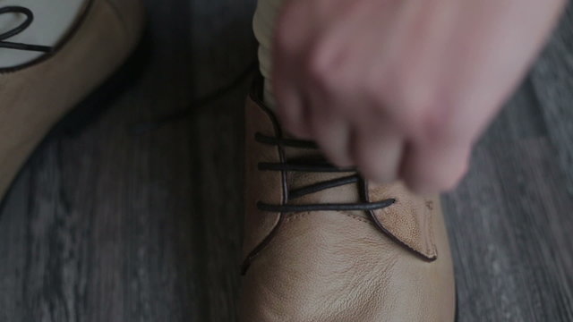 Man trying leather shoelaces