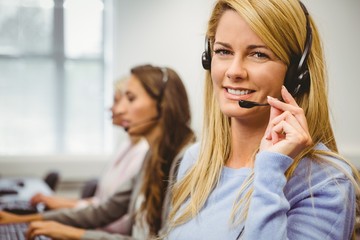 Smiling call centre agent talking on the headset