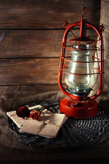 Kerosene lamp with dried rose and letter