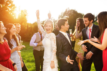 Newlyweds with guest on their garden party
