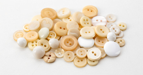 Obraz premium Beige sewing buttons isolated on white