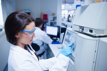 Young chemist using the machine