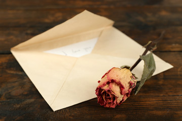 Envelope with love letter and dried rose