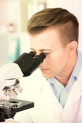Young male researcher carrying out scientific research in lab