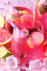 Pink lemonade in glasses on bright background