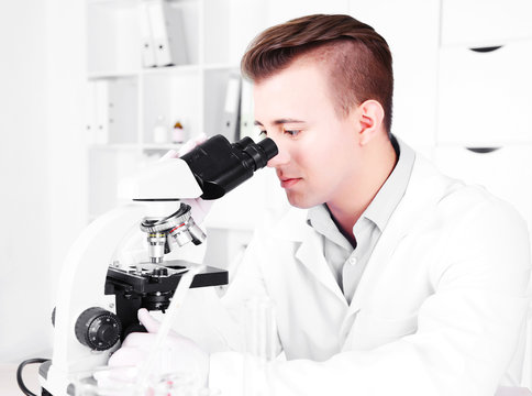Young male researcher carrying out scientific research in lab