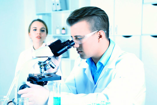 Young researcher carrying out scientific research in lab