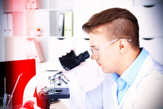 Young male researcher carrying out scientific research in lab