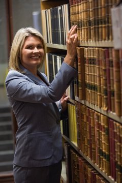 Lawyer picking book in the law library