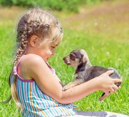 A child on a walk with a little puppy