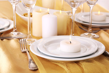 Beautiful holiday table setting in white and gold color