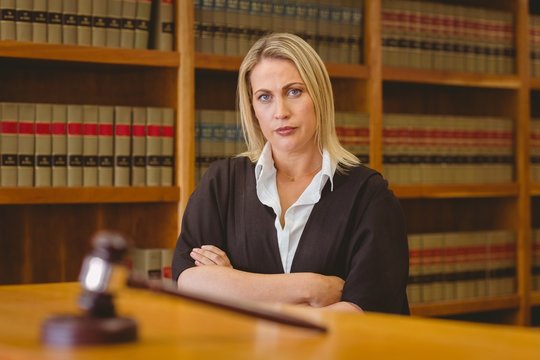 Serious lawyer looking at camera with arms crossed