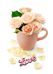 Beige roses in a cup