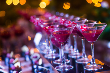 Line of different colored cocktails with smoke on a party