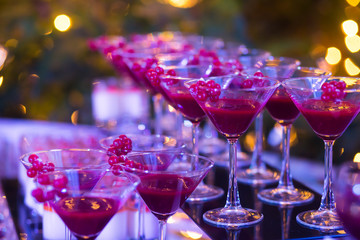 Line of different colored cocktails with smoke on a party