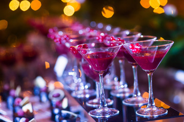 Line of different colored cocktails with smoke on a party
