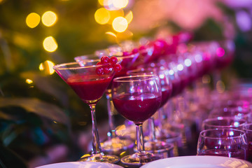 Line of different colored cocktails with smoke on a party