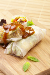 Portion of spring rolls on a bamboo board