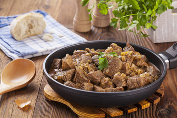 Beef stew - wooden background