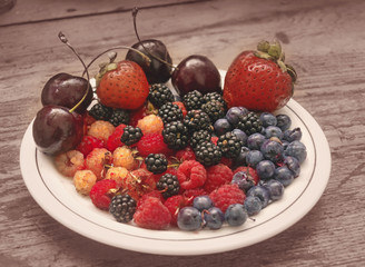 Different berries on a white plate