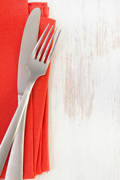 Red Napkin With Knife And Fork On White Background