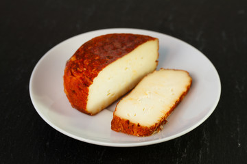 cheese on dish on black background