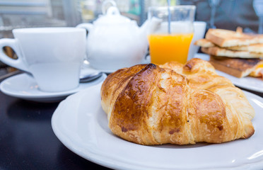 Breakfast with coffee and croissants