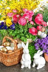 Easter home decoration with fresh spring flowers, bunny and eggs