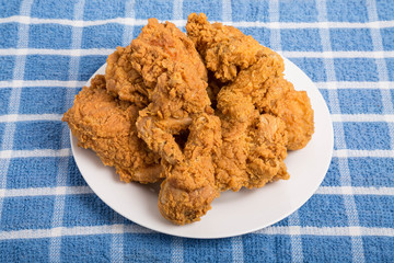 White Plate of Fried Chicken on Blue Towel
