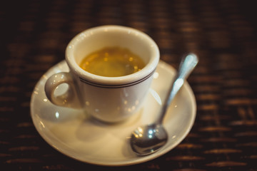 Close up of espresso cup on wood surface. Macro