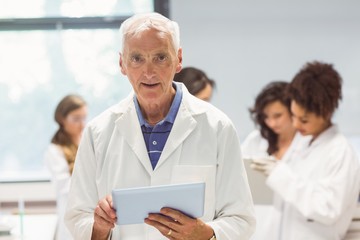 Fototapeta premium Science lecturer holding tablet pc in lab