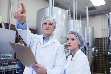 Man pointing at something to his colleague