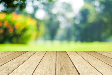 Empty perspective wood over blur green leaves bokeh background