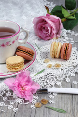 Fototapeta na wymiar Valentine's Day: Romantic tea drinking with macaroon and hearts
