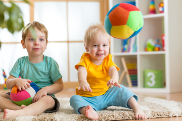 children playing with soft ball in playroom