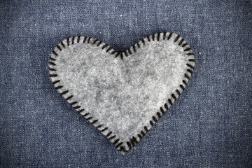gray heart on blue fabric background