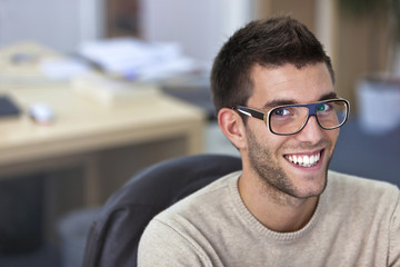 Obraz premium Portrait of a smart an handsome young man in office