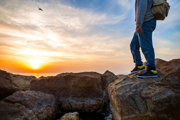 traveler with backpack looking at horizon at airplane