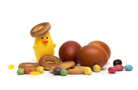 Happy Easter. Easter eggs with candy and cookies. Photo.