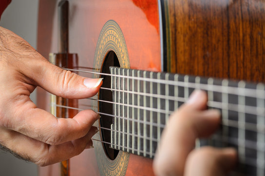 Closeup of a Man hands playing classical gutar