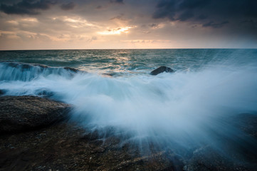 sea waves lash line impact rock on the beach