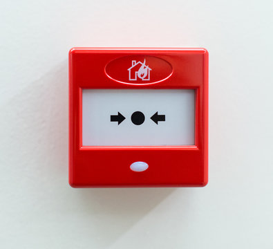 Fire alarm button on the wall.