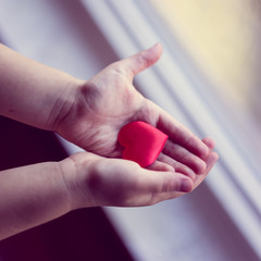 Child is holding a small heart